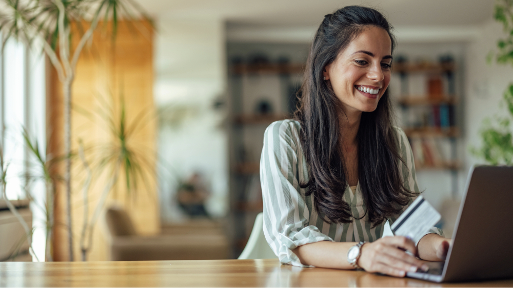 Woman on laptop learning about budget DIY credit management