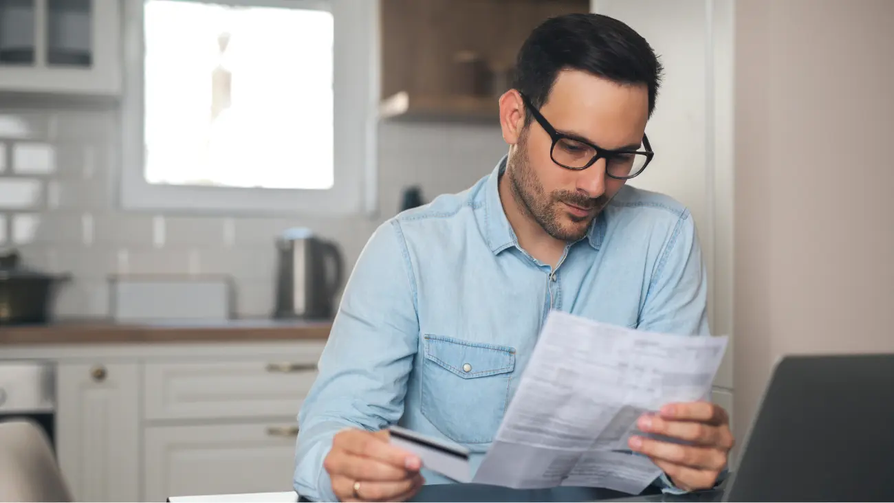 Man practicing DIY credit management in his home